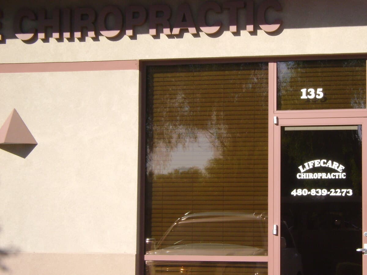 The LifeCare Chiropractic entrance at Suite 135, with the practice name and phone number on the door.